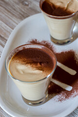 coffee ricotta, spoon dessert in glass cup served in a white plate