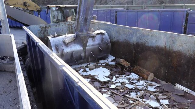 Stockholm, Sweden An industrial compacter crushes furniture in a container at a municipal dump. 