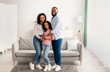 Portrait of a happy black family smiling at home