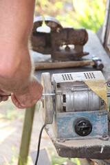 the person working with the machine sharpens