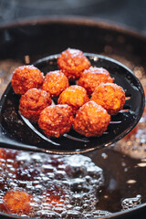 Frying home made italian traditional meatballs