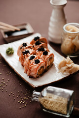 Obraz na płótnie Canvas Sushi rolls with salmon and black caviar