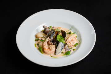 Shrimp and mussels platter in sauce on the white plate
