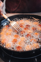 Frying home made italian traditional meatballs