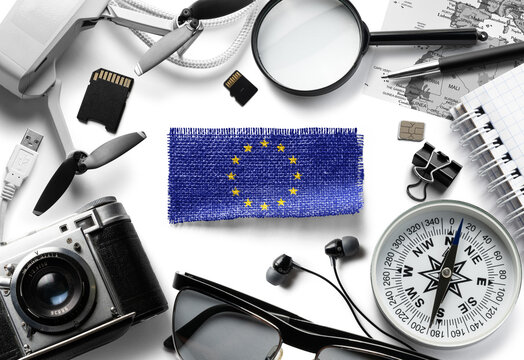 Flag of European Union and travel accessories on a white background.