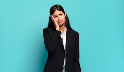young hispanic telemarketer woman feeling bored, frustrated and sleepy after a tiresome, dull and...