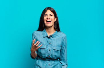 young hispanic casual woman looking angry, annoyed and frustrated screaming wtf or what’s wrong...