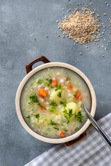 Krupnik, polish barley soup with vegetables in a bowl