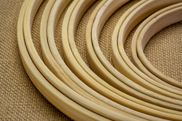 set of bamboo embroidery hoops against burlap canvas, craft and hobby concept