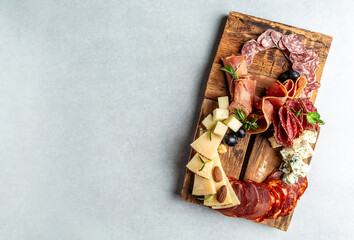 Italian appetizers or antipasto set with gourmet food on a wooden board. Mixed cheese and meat snacks of the number eight. International Women's Day, top view