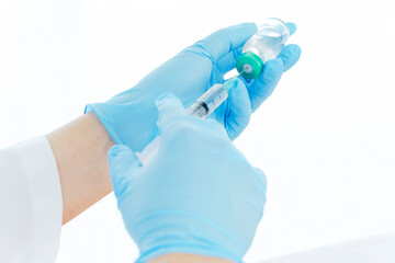 Close up vaccines fight against virus, doctor or scientist in laboratory holding a syringe with liquid vaccines.