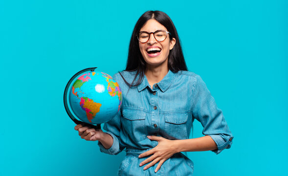young hispanic woman laughing out loud at some hilarious joke, feeling happy and cheerful, having fun. earth planet concept