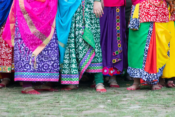 Colourful drapes of sari, traditional Indian dress. Young Bengali dancers awaiting their turn to...