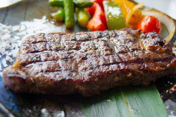 Sirloin steak ready to eat in a delicious plate with grilled vegetables