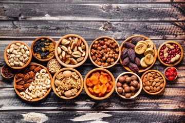 Various Nuts and dried fruits in wooden bowls.