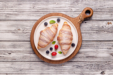 Breakfast with croissants and fresh fruits.