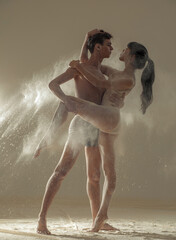 Two ballet dancers perform dance against background of white flour cloud in air.