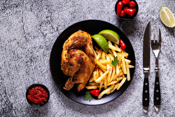 Half roasted chicken Piri Piri with french fries