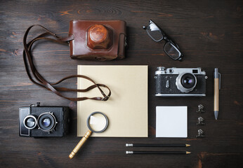 Vintage travel stuff with retro camera on wood table background. Top view. Flat lay.