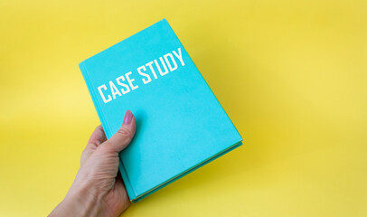 Case Study text on a green notebook in a female hand on a white background.