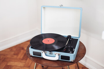 Retro blue record player on a wooden background