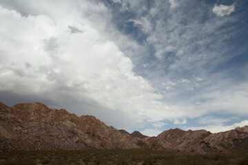 Cloudscape in the the arid desert. View of the sand, sandstone and colorful rocky formation in Mendoza, Argentina.