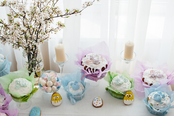 Fototapeta na wymiar Beautiful Easter cakes on a decorated light table. A light holiday of Easter.
