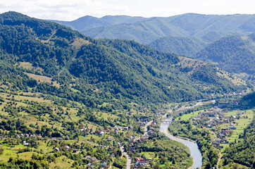 Ukraine Carpathians, a settlement in a valley of mountains, beautiful landscape aerial view