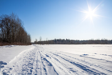 Fototapeta na wymiar Winter Landscape. Snow path leading to the forest.