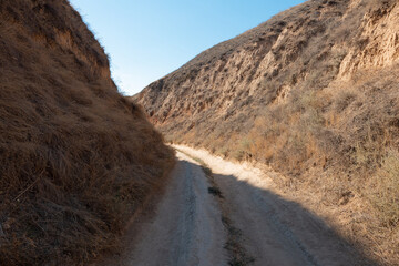 The road between clay mountains and hills. Stanislav, Grand Canyon of Kherson region, Ukraine.