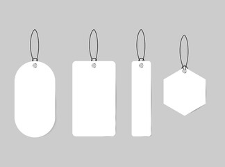 Blank white paper price tags or gift tags in different shapes. Set of labels with cord.