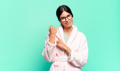 young pretty woman looking impatient and angry, pointing at watch, asking for punctuality, wants to...