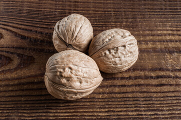 three walnuts close-up on a wooden table