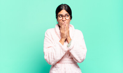 young pretty woman happy and excited, surprised and amazed covering mouth with hands, giggling with...