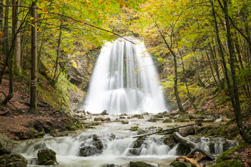 Fototapeta na wymiar breathtaking waterfall in the autumnal forest, Josefsthal upper bavaria