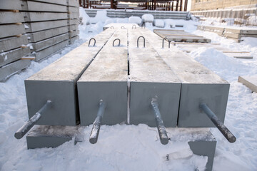 Close-up of the top end of a reinforced concrete pile, where metal threaded rods were placed for anchoring the match of power line poles