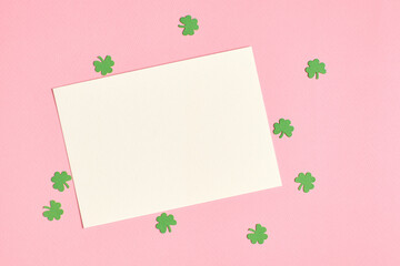 Saint Patricks day greeting card mockup with paper shamrock on pink background