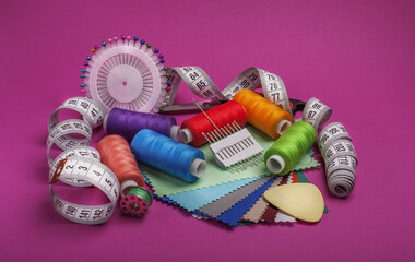 Sewing kit. Colored thread on bobbins and tape measure.