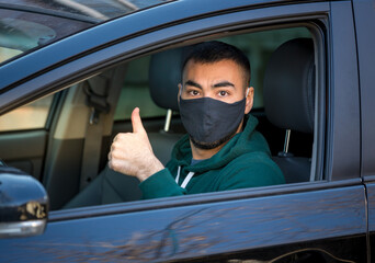 health protection, safety and pandemic concept,taxi driver showing thumbs up sign