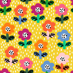 Fototapeta premium Cute seamless pattern with colorful and bright tiny flowers on the yellow polka dots background. Vector doodle flowers. Fun kids pattern for fabric and clothes.