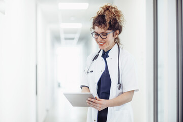 Female doctor talking with colleagues through a video call using tablet. Doctor talking with patient through video call using tablet. 