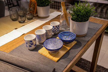 Chinese table setting. Blue and withe empty bowls, cups and bamboo chopsticks