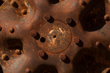 Rusty metal parts belonging to an old abandoned and disused tractor, formerly used in the agronomic industry, near Campo de Borja, Zaragoza province, Aragon, Spain.