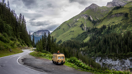Fototapeta na wymiar camper van in the forest mountain road in the mountains
