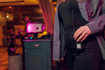 Close-up of female with Walkie talkie keeps on jeans.