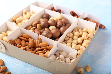 Different grade of nuts in a box on a light background