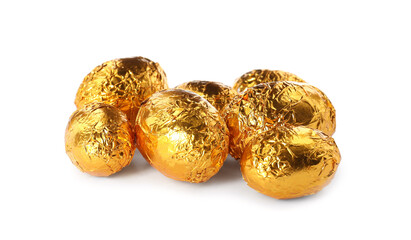 Chocolate eggs wrapped in golden foil on white background