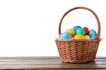 Fototapeta na wymiar Colorful Easter eggs in wicker basket on wooden table against white background