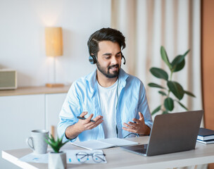 Online Tutoring. Young arab tutor in headset having video call with students