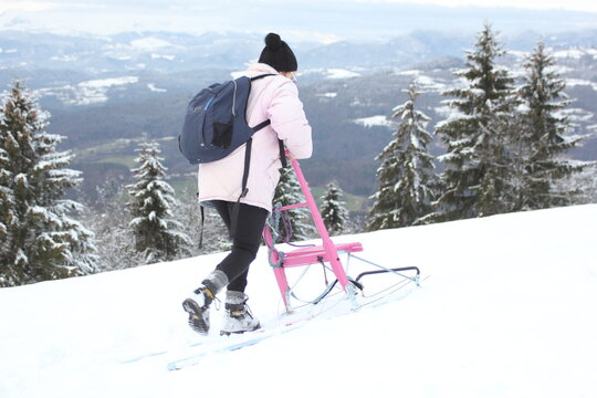 kicksled in the mountins. Slovenia in winter time. Scandinavian type of sled called  spark